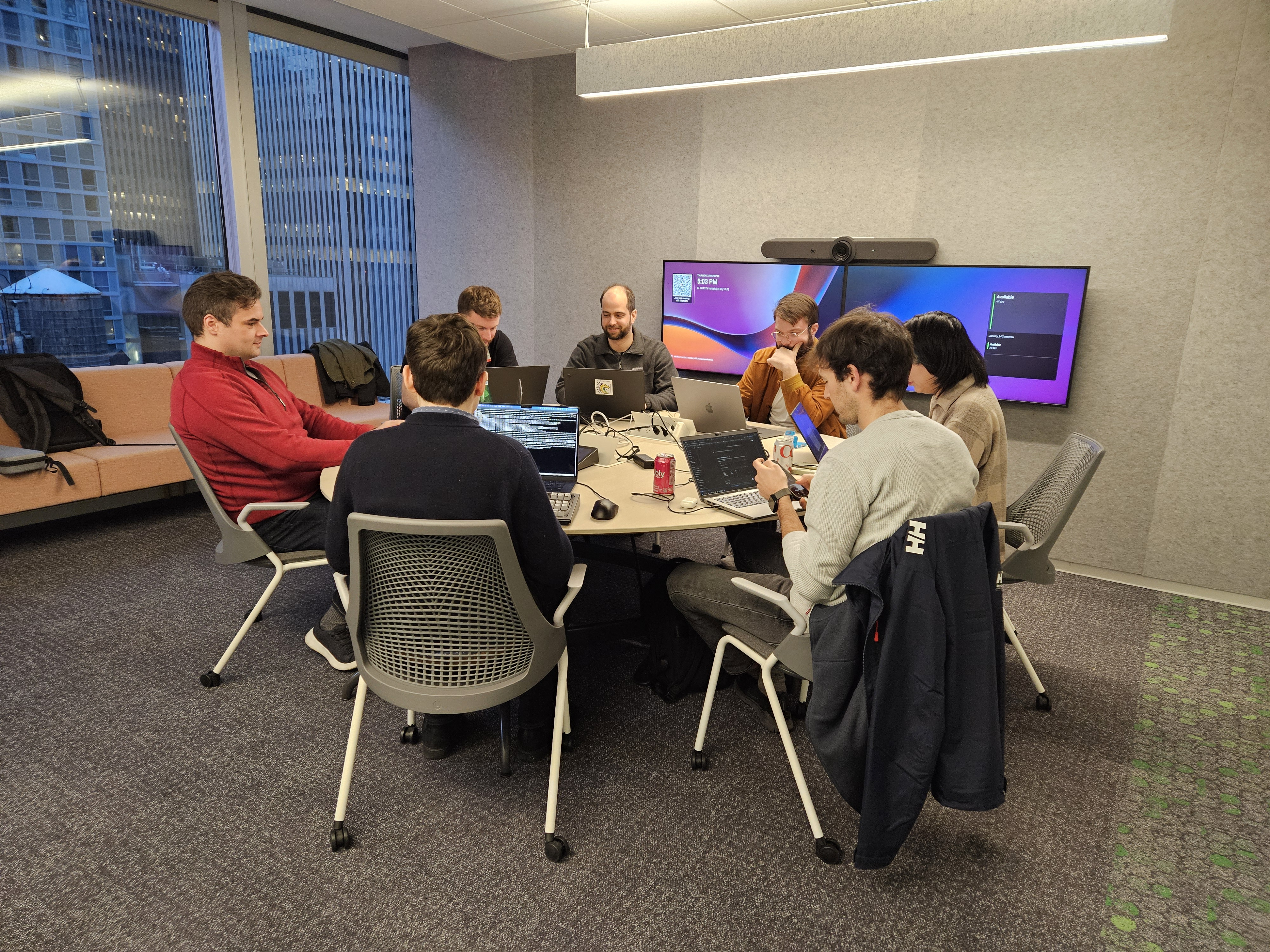 Several hackathon members busy coding. They give the impression of serious and intense work happening! busy coding